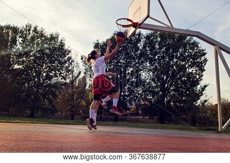 Woman Basketball Player Have Treining And Exercise At Basketball Court At City On Street