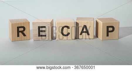 Concept Word Recap On Wooden Cubes On A Grey Blue Background
