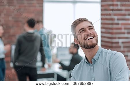 Cheerful man smiling in office.
