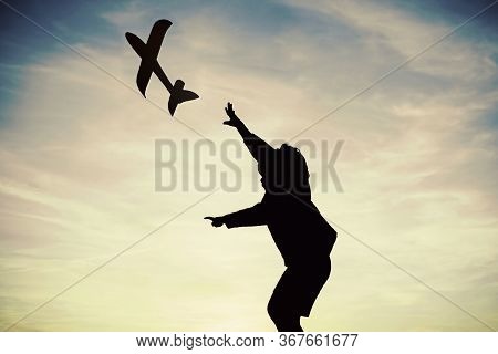 Child Pilot Aviator With Airplane Dreams Of Traveling In Summer In Nature At Sunset. Active Child Pl