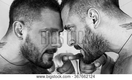 A Mirror Where A Man Watching Himself. Man And Mirror. Bearded Hispanic Man Pointing Finger At Mirro