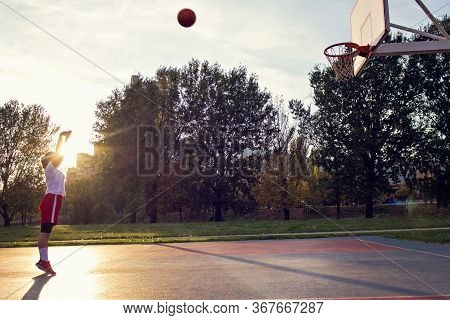 Woman Basketball Player Have Treining And Exercise At Basketball Court At City On Street
