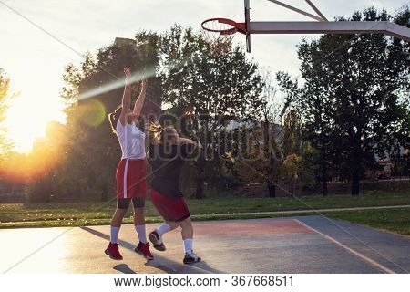 Woman Basketball Player Have Treining And Exercise At Basketball Court At City On Street