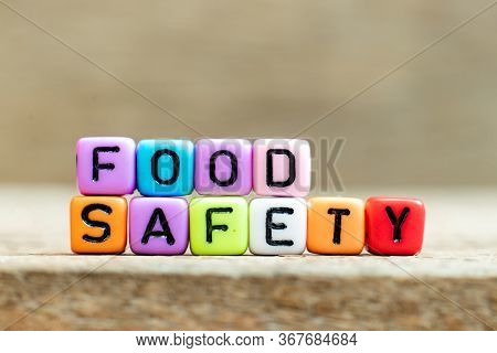 Colorful Bead With Black Letter In Word Food Safety On Wood Background
