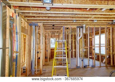 Home Construction With Hot Red And Cold Blue Pex Pipe Layout In Pipes And Exposed Beams