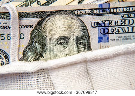 A Hundred-dollar Bill With A Medical Mask .the Concept Of Coronavrius Epidemic