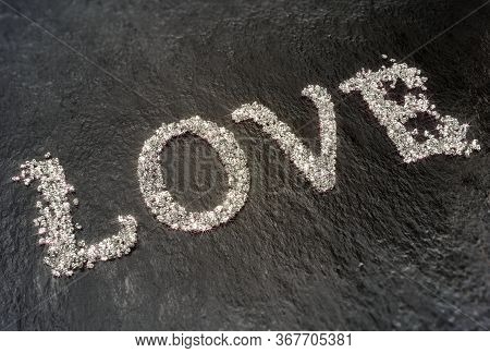 The Word Love Made Of Small Shiny Diamonds On Black Concrete, 3d Illustration