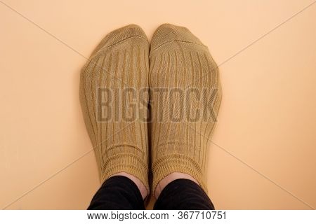Socks Light Brown On Legs Top View. Short Knitted Socks For Sports On Women's Feet. Soft Comfortable