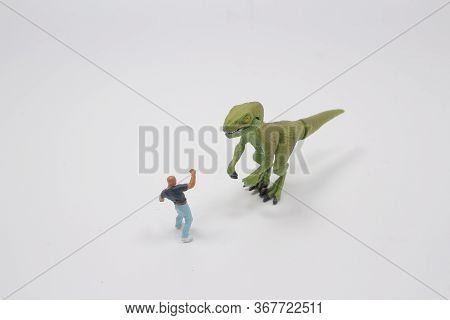 A Timy Figure Man Fight The Dinosaur Toy