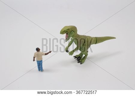 A Timy Figure Man Fight The Dinosaur Toy
