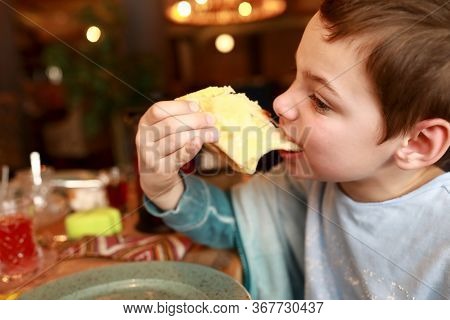 Kid Eating Megrelian Khachapuri In Georgian Restaurant