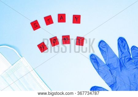 Medical Protective Mask On Blue Background With Protective Gloves And Lettering Inscription Stay Hom