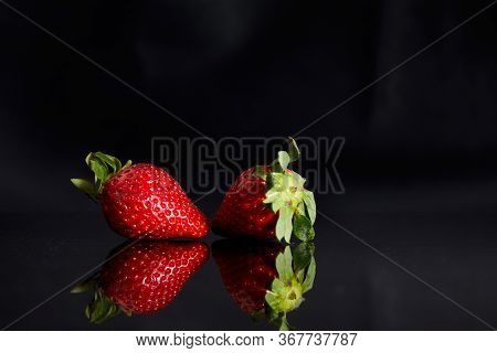 Strawberries On A Black Background With Reflection