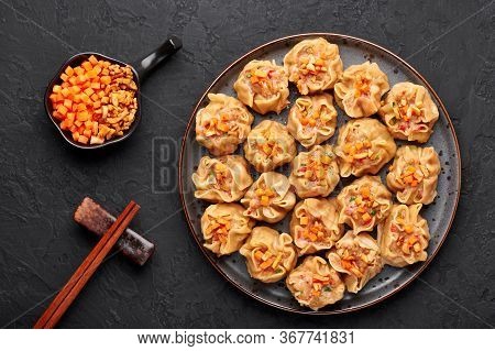 Shumai Or Kanom Jeeb Or Steamed Pork And Shrimp Dumplings On A Black Plate On Dark Slate Backdrop. S