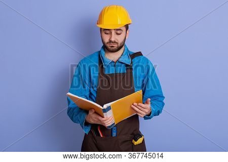 Indoor Picture Of Upset Unsatisfied Experienced Engineer Posing Isolated Over Blue Background In Stu