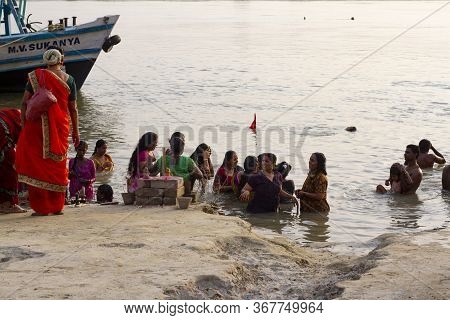 Mayapur, West Bengal, India - April 28, 2019. Indian People Take A Bath In The Sacred River Ganges