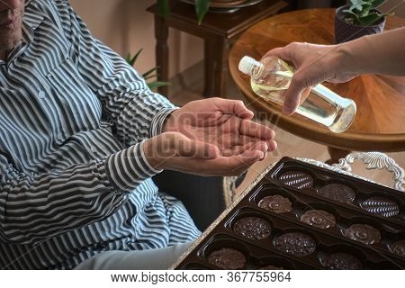 Muslims Celebraid Eid At Home Eating Chocalate And Having Cologne On Hands