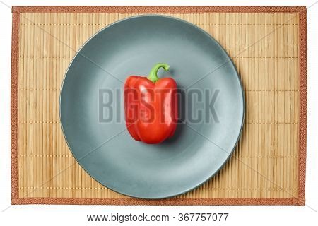 Color Still Life - Red Bell Pepper On A Gray Plate On A Cane Serving Mat
