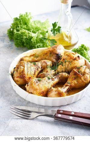 Fried Chiken Drumstick Served In White Bawl Wiht , Salad And Turmeric