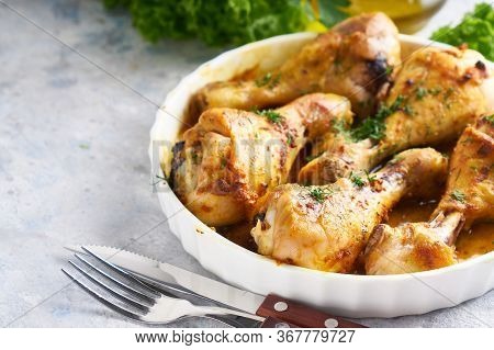 Fried Chiken Drumstick Served In White Bawl Wiht , Salad And Turmeric
