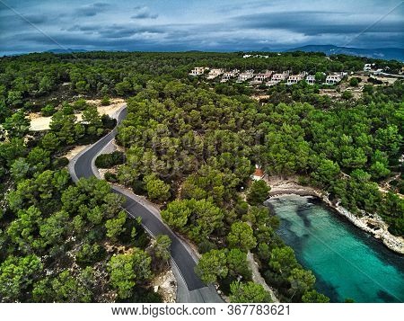 Aerial Photography Cove With Green Lagoon Turquoise Water, Hillside Houses In Small Village Of Banya