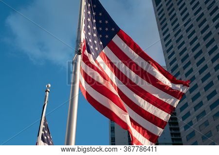 Happy 4th Of July Usa Independence Day. Waving American National Flag And Skyscrapers On The Backgro