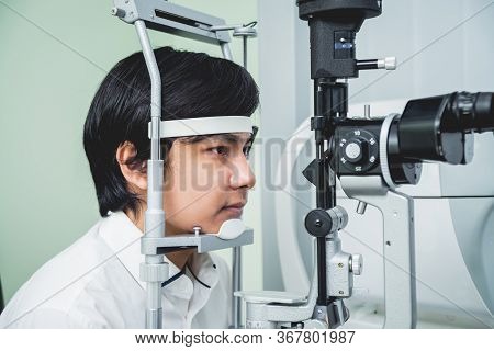 Consultation With An Ophthalmologist. Young Asian Man And Woman Doctor