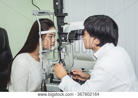 Consultation With An Ophthalmologist. Young Asian Woman And Doctor