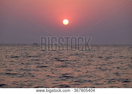 CANDOLIM, INDIA - FEBRUARY 18, 2020: Sunset at Candolim Beach, North Goa, India