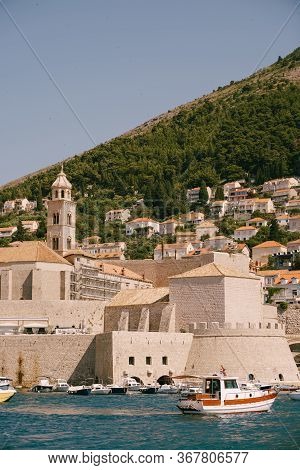 The Old Port Harbor Is Porporela, Near The Walls Of The Old Town Of Dubrovnik, Croatia. A Ship With 