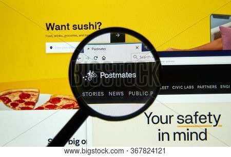 Montreal, Canada - May 2, 2020: Postmates Official Website Under Magnifying Glass. Postmates Is An A