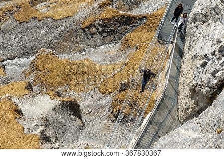 Lauterbrunnen, Switzerland - October 2019: Tourists Walking On The Thrill Walk, The Cliff Pathway Do