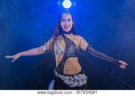 Girl Dancing Belly Dance, Fusion Or Tribal. A Woman In A Beautiful Costume Demonstrates Charming And