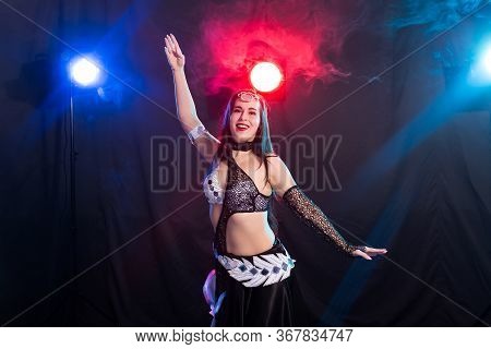 Girl Dancing Belly Dance, Fusion Or Tribal. A Woman In A Beautiful Costume Demonstrates Charming And