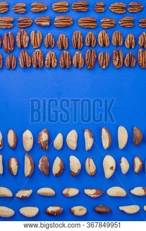 Pekan And Brazil Nuts On Blue Background. Healthy Food