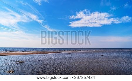 Seascape. Sandy Beach On The Sea On A Sunny Day With Beautiful Clouds.