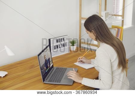Work Online. The Remote Employee Has A Video Chat Call Using A Laptop On A Desk Not In The Workplace
