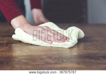 Young Woman Claning Brown And Wooden Desk
