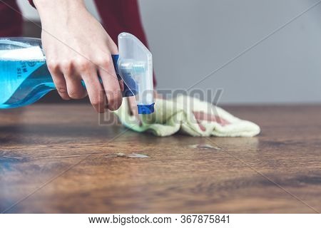 Young Woman Claning Brown And Wooden Desk