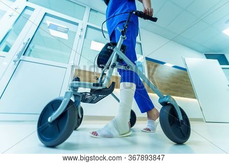 Patient On Rollator With Hand Brakes Moving In Hospital