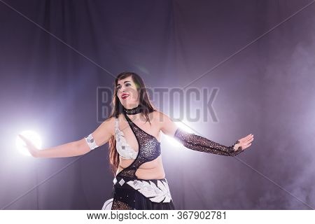 Girl Dancing Belly Dance, Fusion Or Tribal. A Woman In A Beautiful Costume Demonstrates Charming And
