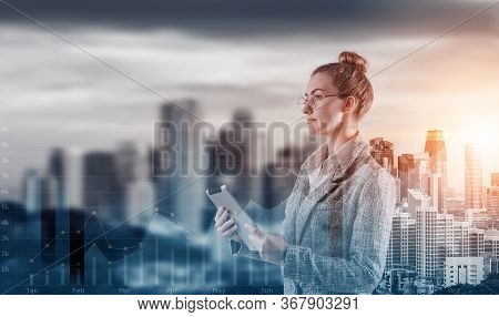 Double Exposure Of Attractive Business Woman Woking On Tablet On Cityscape Background With Infograph