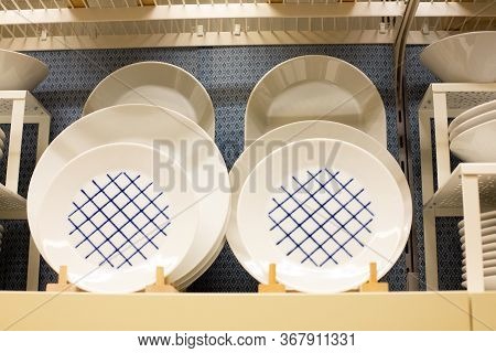 A Large Set Of Multi-colored Dishes On The Shelves Of The Supermarket. Group Of Stylish New Dishes C