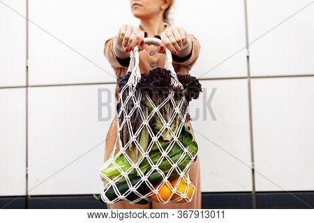 Girl Is Holding Mesh Shopping Bag With Vegetables, Greens Without Plastic Bags. Zero Waste, Plastic 