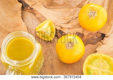 Naranjilla Or Lulo Fruit (lat. Solanum Quitoense) On Wooden Board With Freshly Prepared Naranjilla J
