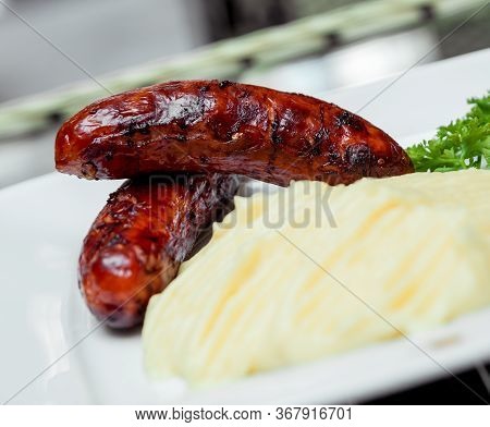Potatoe With Sousages On The White Plate