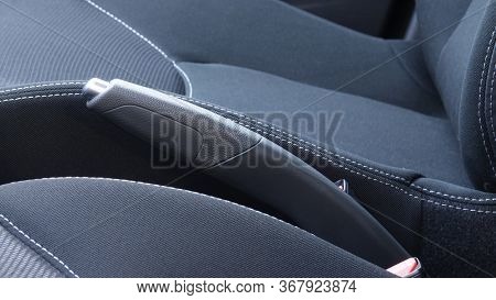 Modern car handbrake lever interior between front seats