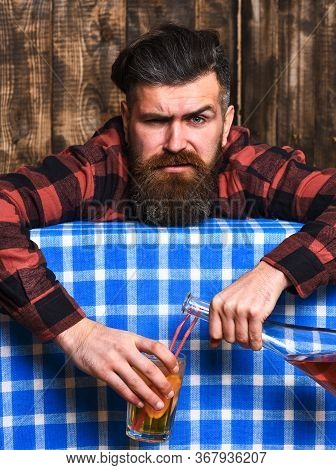 Barman With Beard And Painful Grimace Face Holds Cocktail