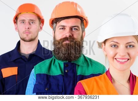 Cheerful Team Of Three Constructor Workers, Men And Woman