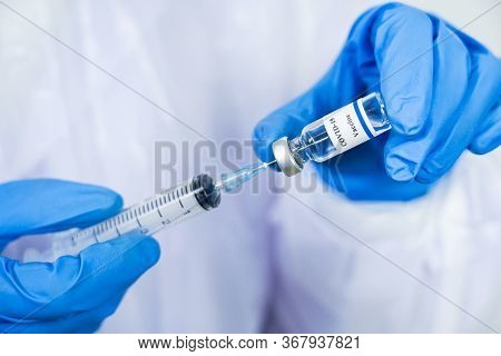 Doctor, Scientist, Researcher Hand In Blue Gloves Or Protective Suit Preparing For Human Clinical In